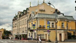 A yellow building with multiple windows and balconies.