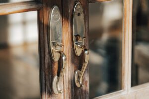 a close up of a door handle on a wooden door